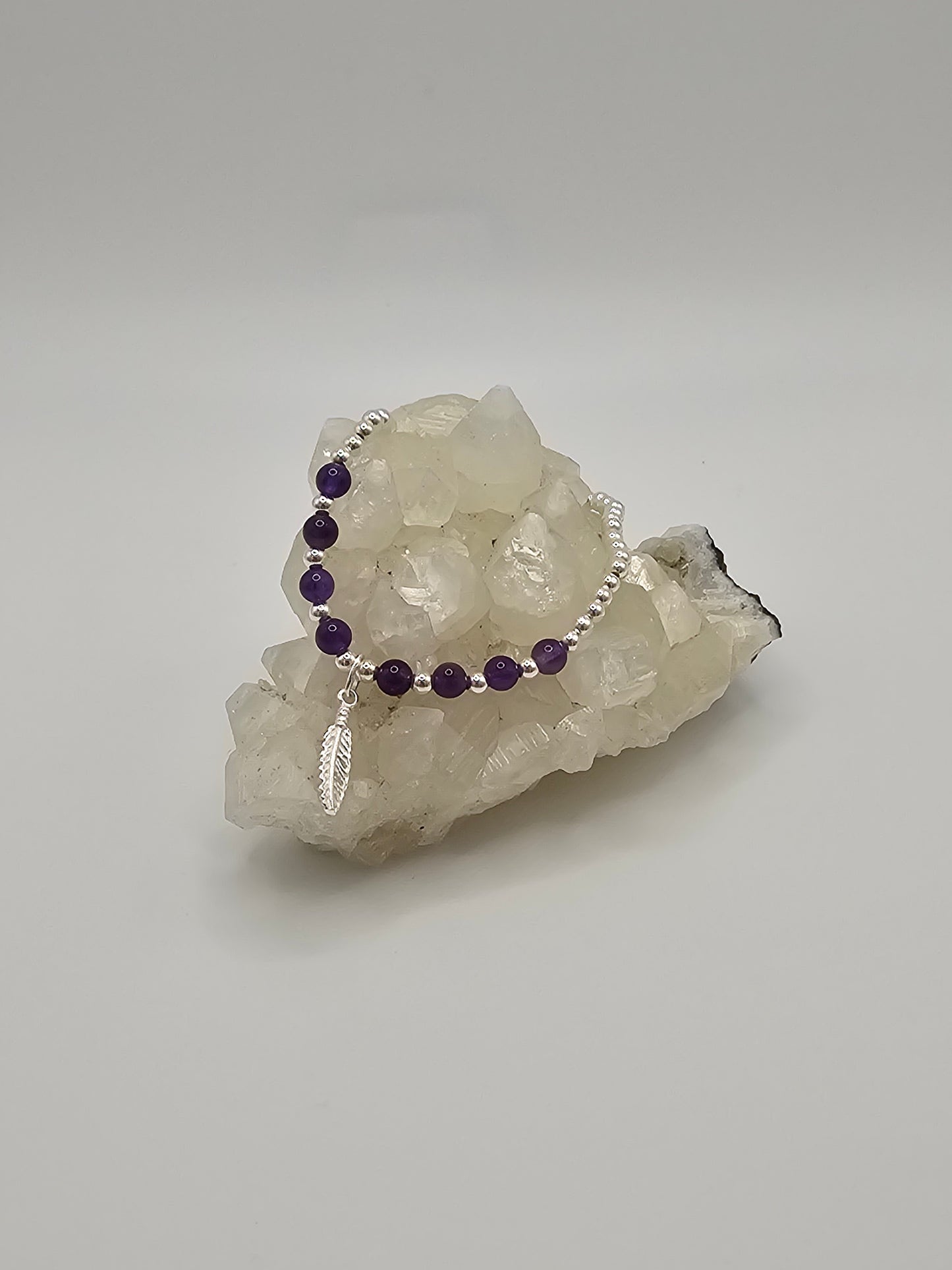 Sterling Silver Stretch Bracelet with Purple Amethyst and Sterling Silver Feather